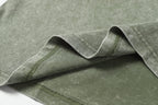 Sage green T-shirt fabric close to hem with double-stitch seam detail