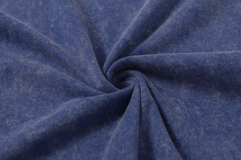 Blue T-shirt fabric with draped fold texture.