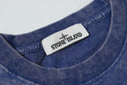 Blue crew-neck T-shirt with Stone Island inner collar label.