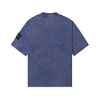 Blue crew-neck T-shirt, back view, short sleeves, Stone Island sleeve patch.