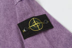 Stone Island T-shirt with black logo patch and yellow emblem on sleeve.