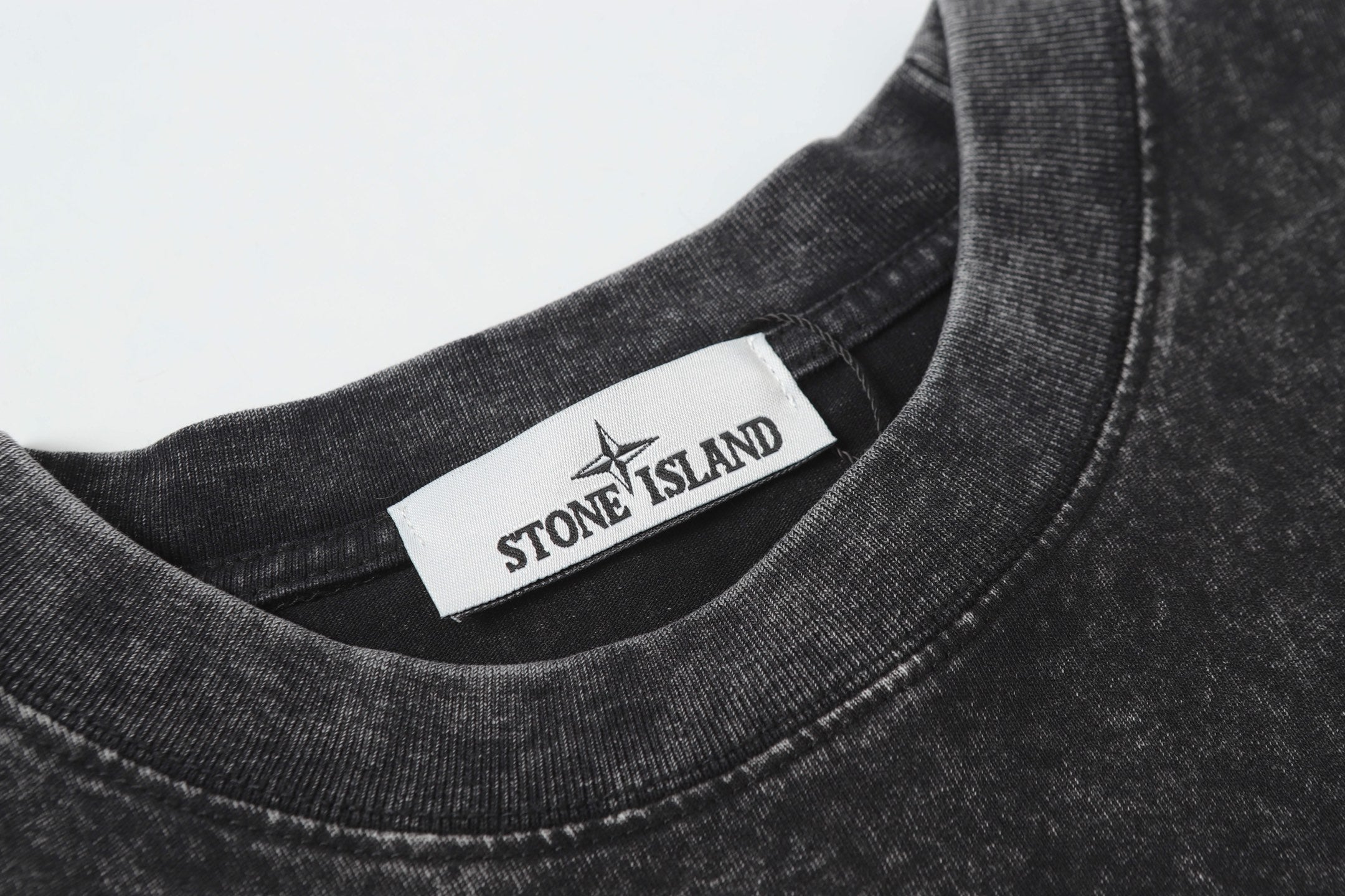 Dark charcoal crewneck T-shirt collar with brand neck label