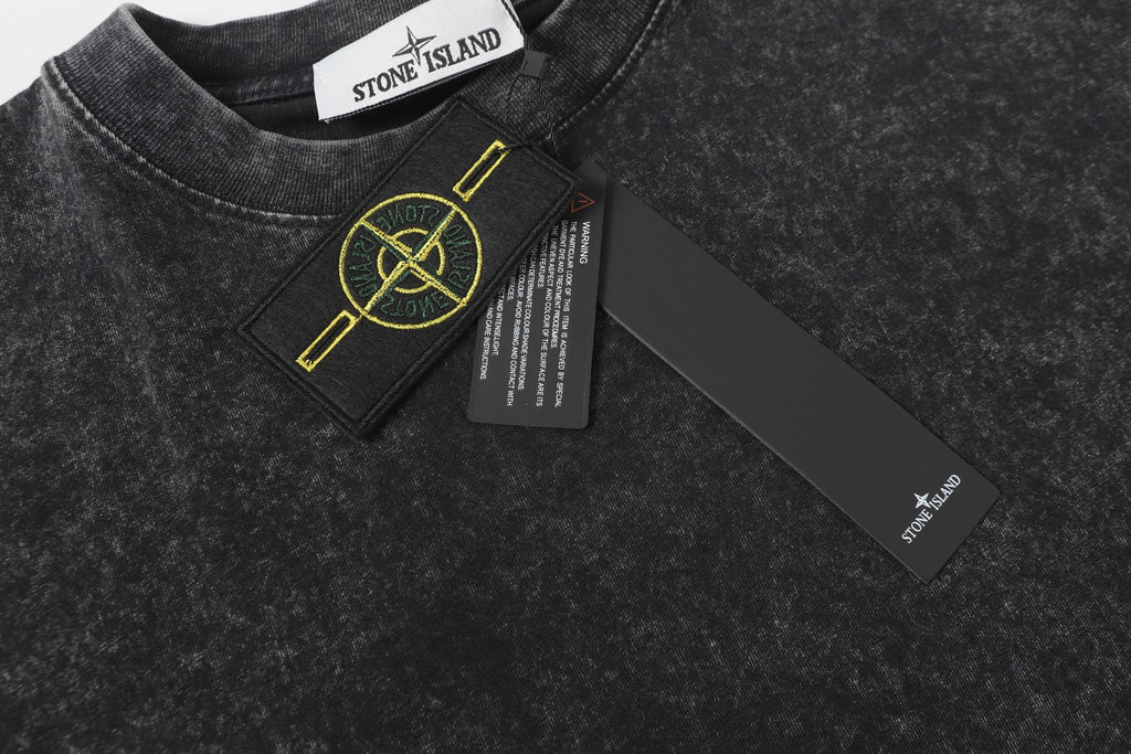 Dark charcoal T-shirt with crew neck, small chest patch and yellow logo detail