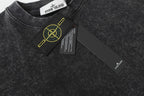 Dark charcoal T-shirt with crew neck, small chest patch and yellow logo detail