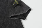 Dark charcoal T-shirt hem and sleeve cuff detail, speckled fabric texture