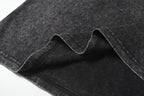 Dark charcoal T-shirt fabric fold and seam detail, speckled texture
