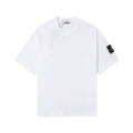 White Stone Island T-shirt with crew neck and small black logo patch on sleeve.