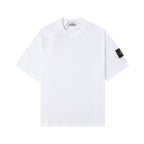 White Stone Island T-shirt with crew neck and small black logo patch on sleeve.