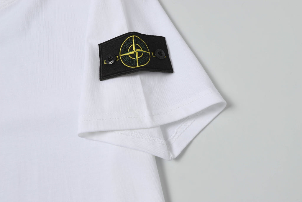 White Stone Island T-shirt sleeve cuff with black gold logo patch.