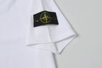White Stone Island T-shirt sleeve cuff with black gold logo patch.