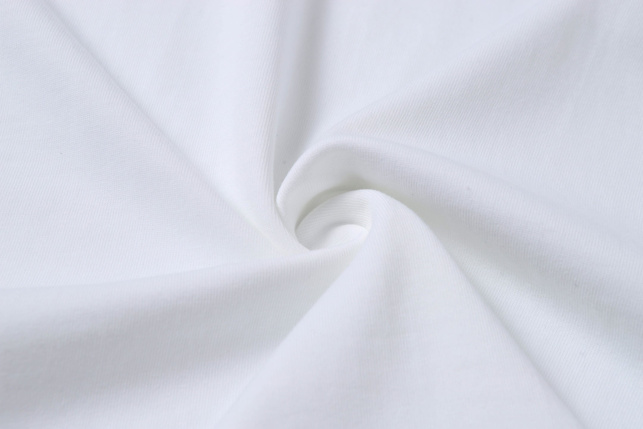 White Stone Island T-shirt fabric close-up with smooth knit texture.