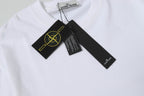White Stone Island T-shirt with attached garment tags near collar.