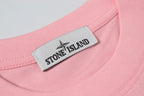 Pink crew-neck T-shirt with white Stone Island logo label