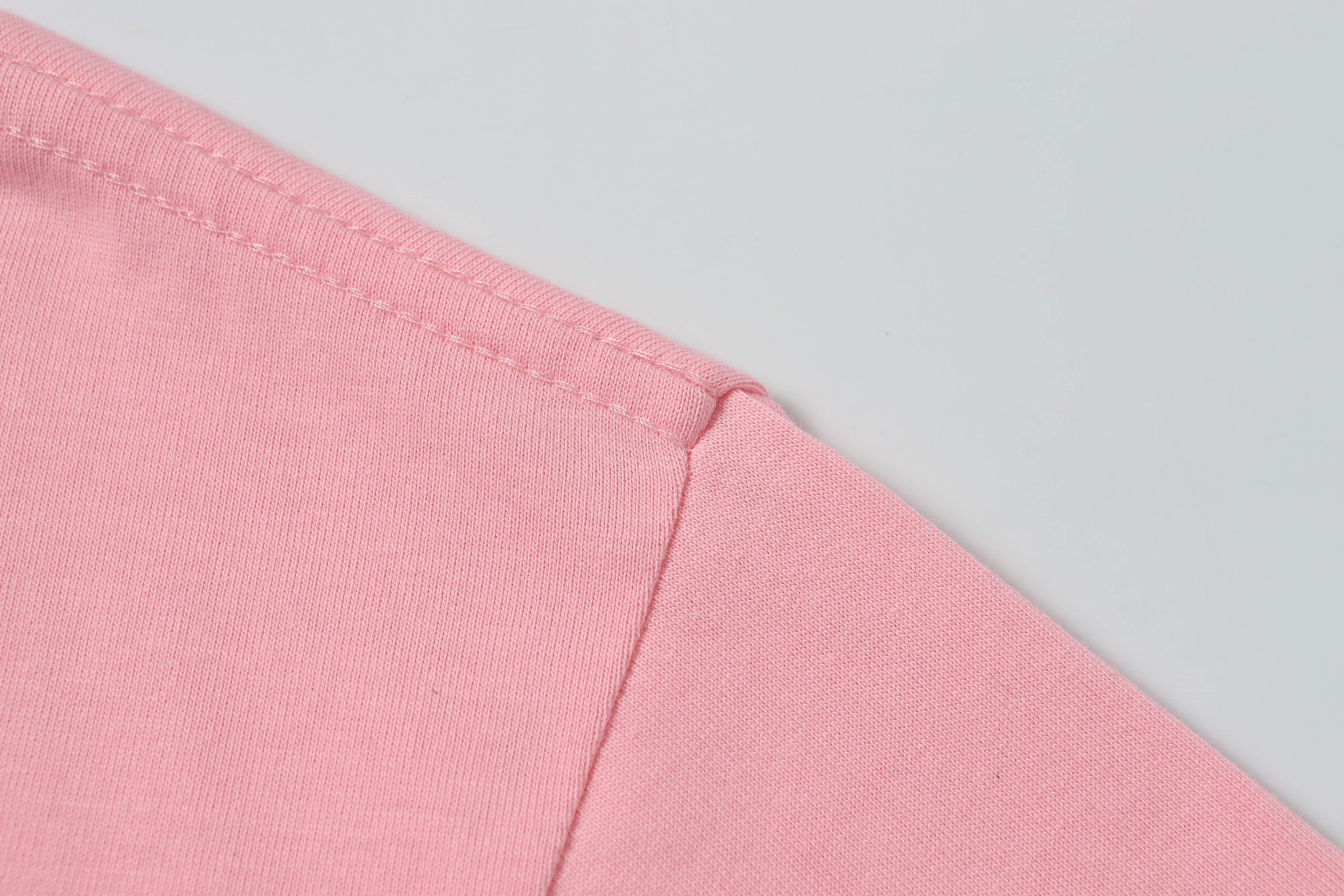 Pink T-shirt side seam with stitched hem detail