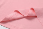 Pink T-shirt knit fabric with folded hem and visible stitching