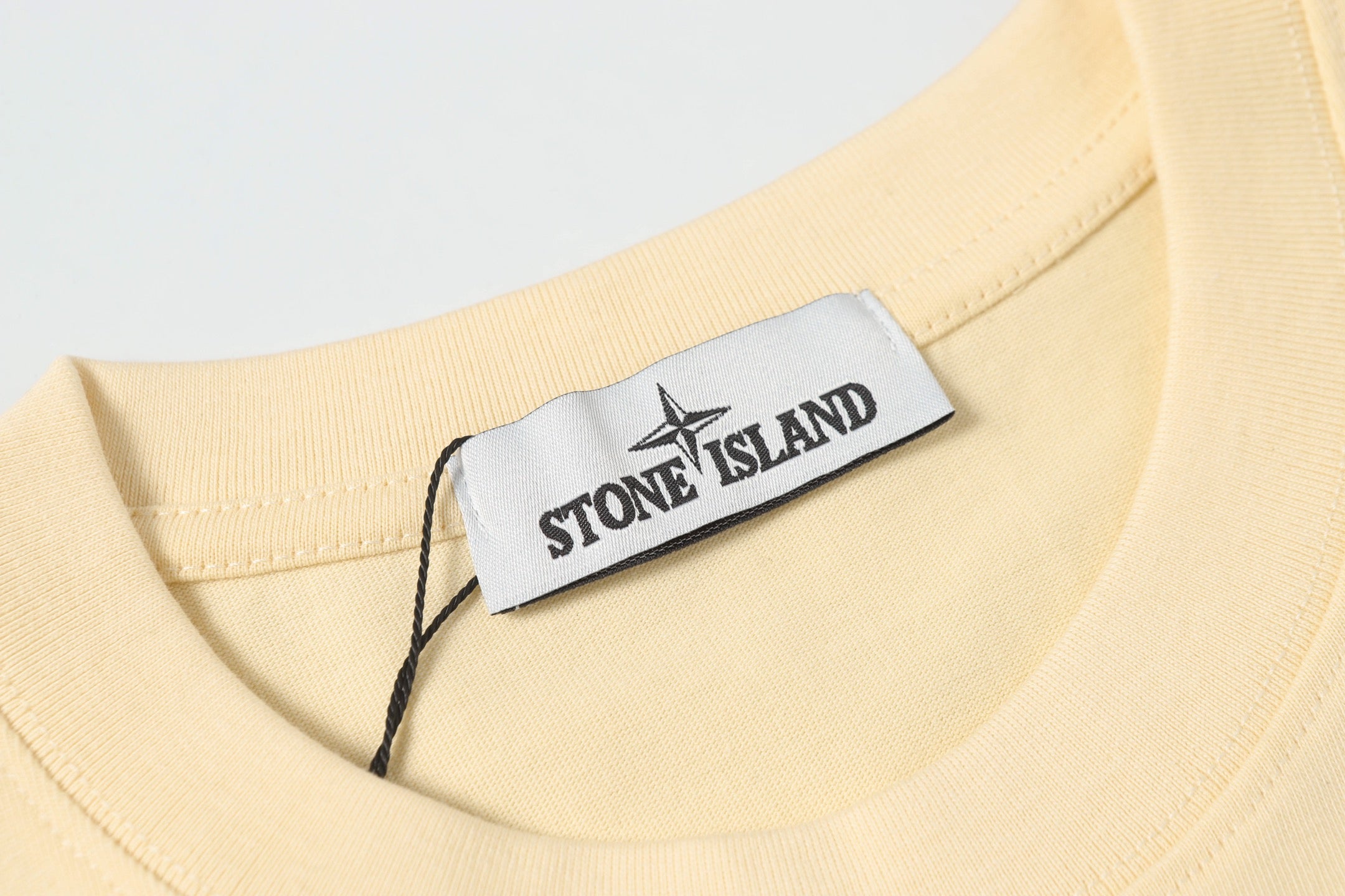 Cream crewneck T-shirt with white brand neck label
