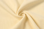 Cream cotton T-shirt fabric close-up with soft knit texture