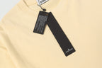 Cream T-shirt neckline with brand label and attached black hangtag