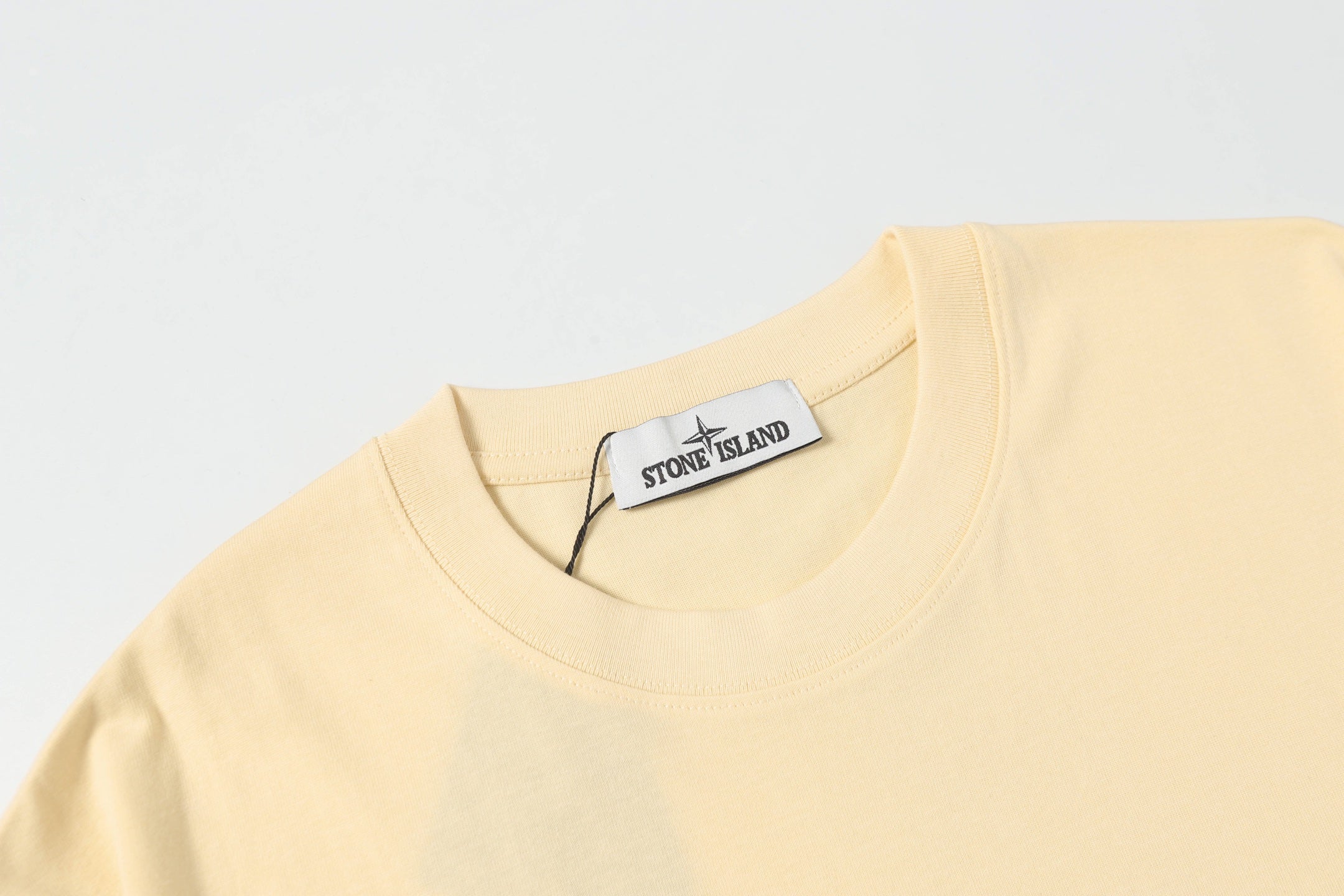 Cream crewneck T-shirt with round neck and white brand label