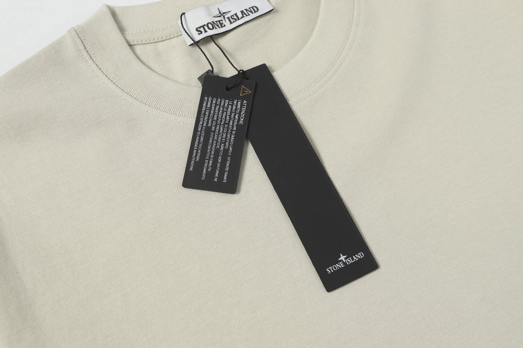 Light beige crew-neck T-shirt neckline with hanging brand tag