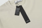 Light beige crew-neck T-shirt neckline with hanging brand tag