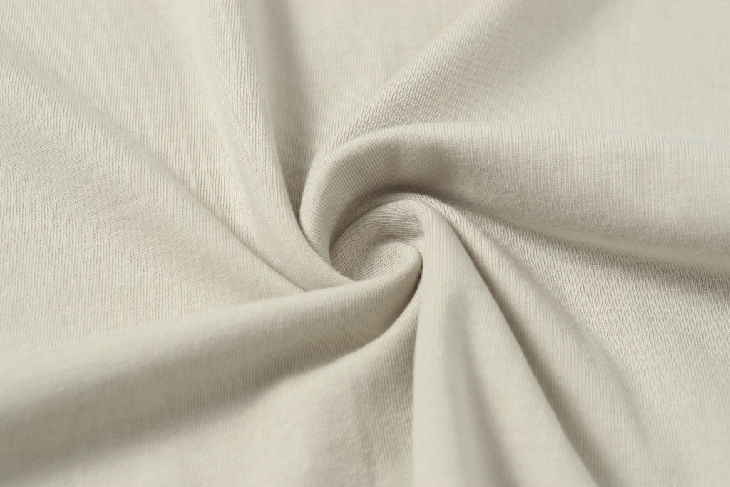 Light beige jersey fabric for a crew-neck T-shirt, close-up