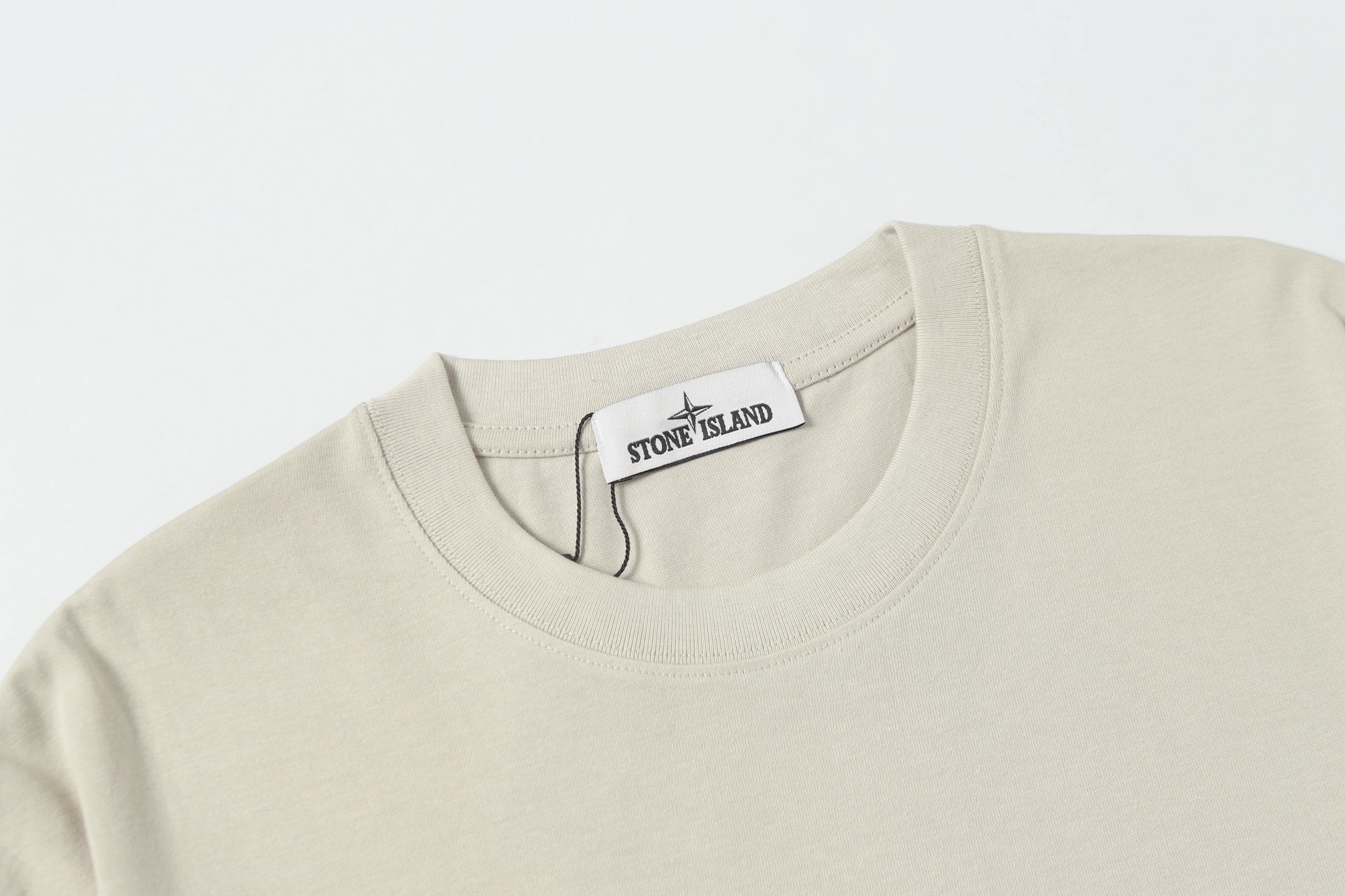 Light beige crew-neck T-shirt with collar label at neckline
