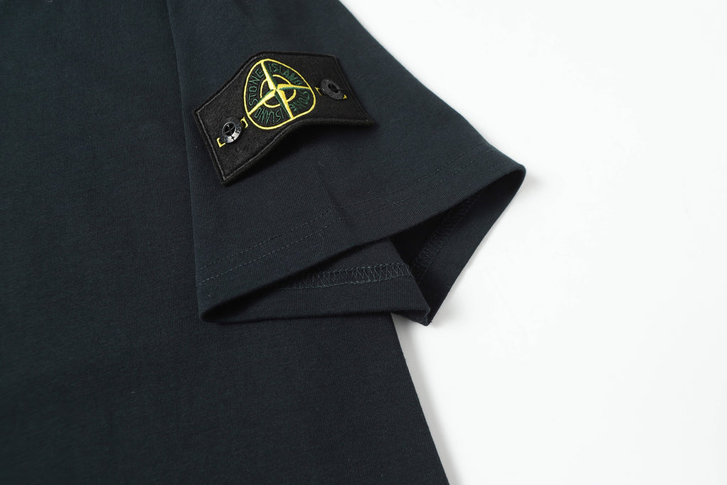 Stone Island T-shirt sleeve label and small yellow logo patch detail