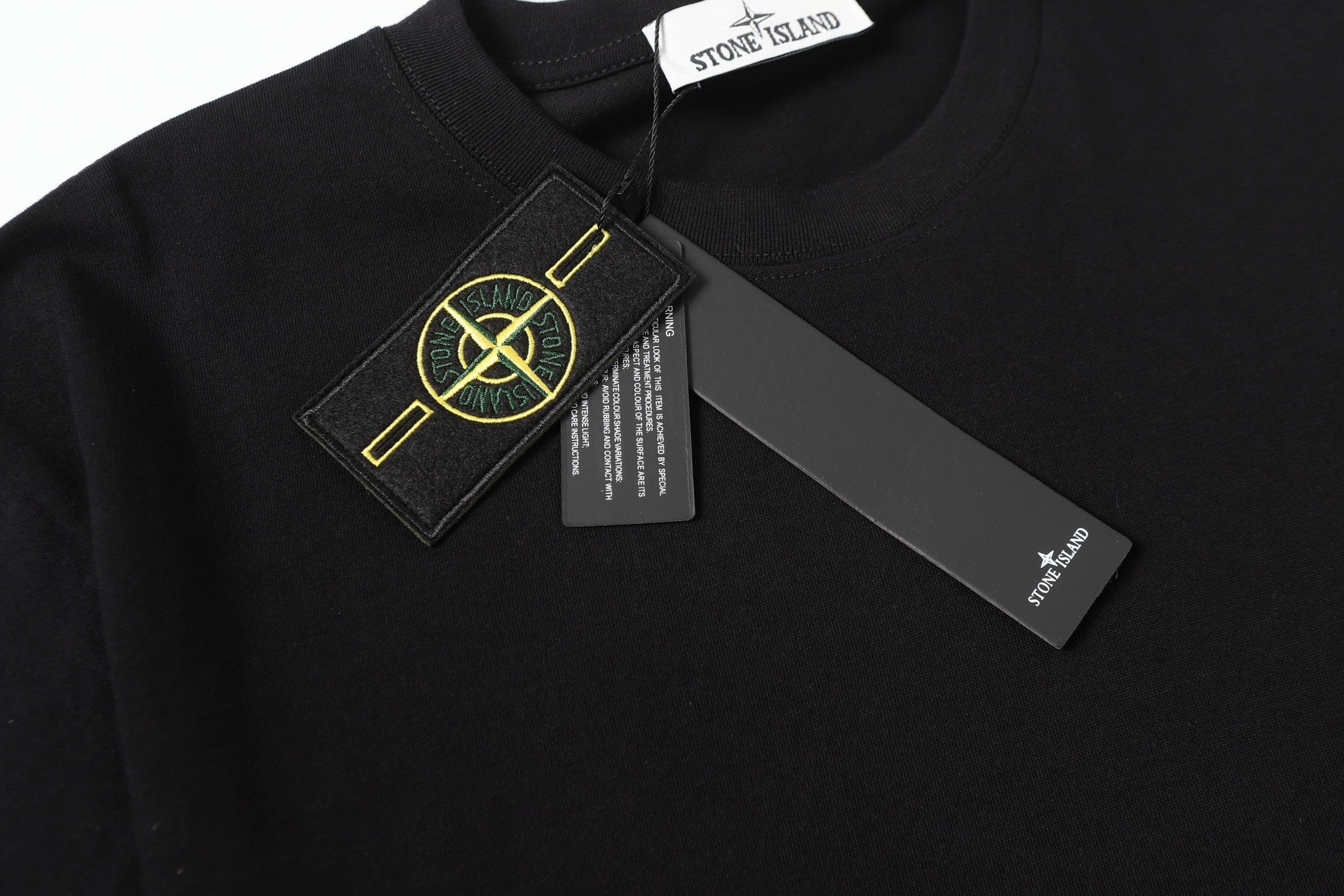 Black crew-neck T-shirt with Stone Island logo label on chest