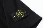 Black short-sleeve T-shirt with embroidered Stone Island patch on cuff