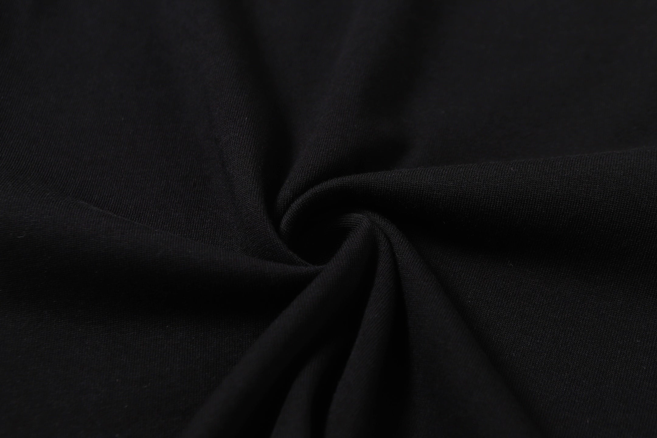 Black T-shirt fabric close-up, smooth knit texture