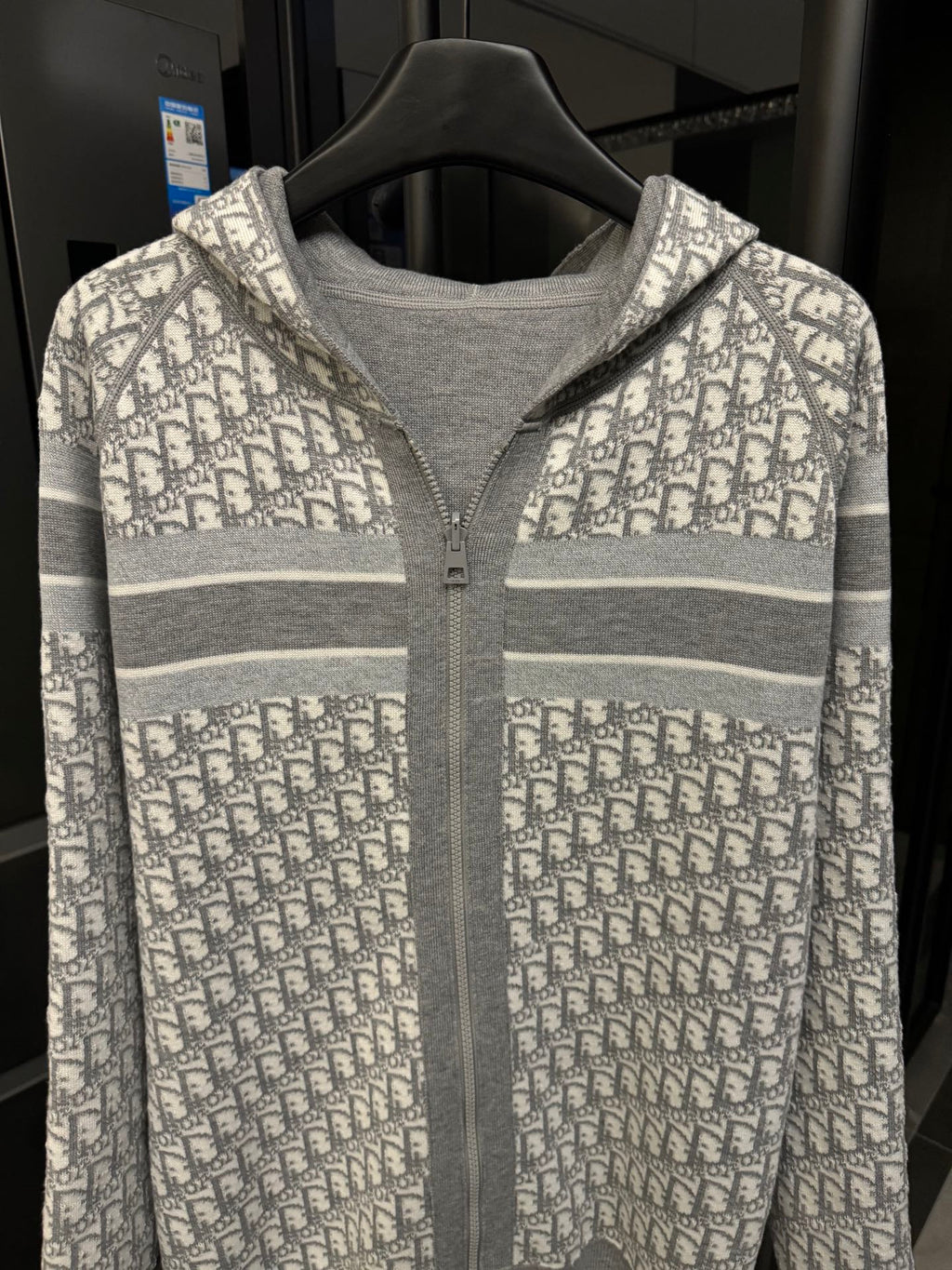 Front of gray zip hoodie with Dior monogram yoke and hood
