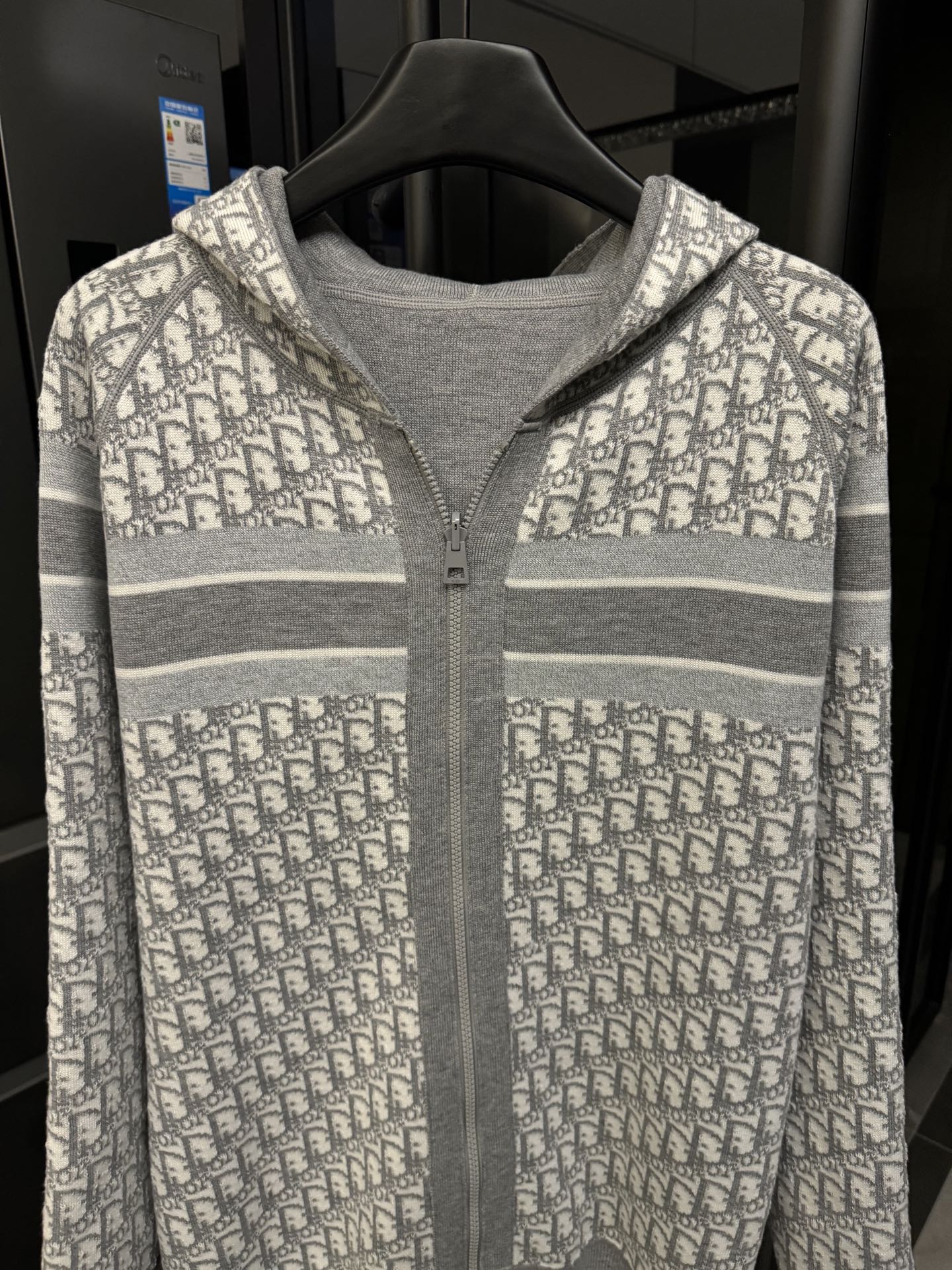 Front of gray zip hoodie with Dior monogram yoke and hood