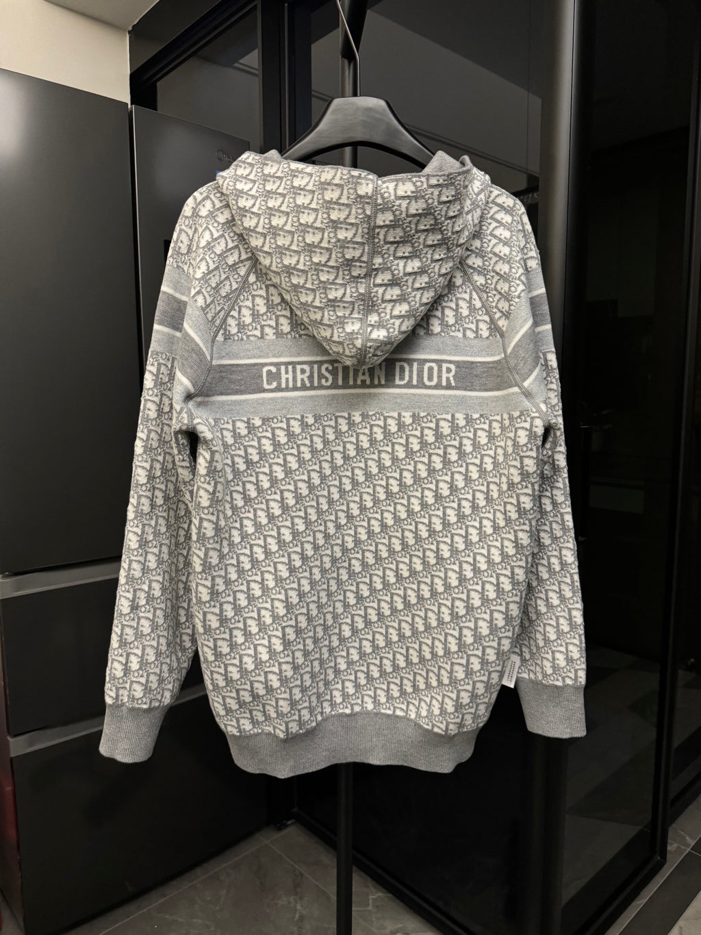 Back view of gray zip hoodie with Dior monogram print and CHRISTIAN DIOR logo stripe