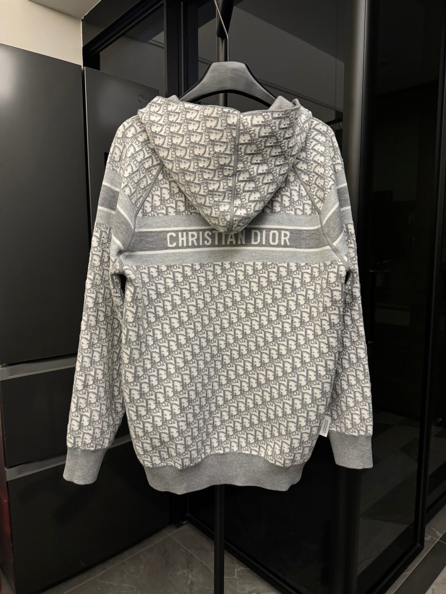 Back view of gray zip hoodie with Dior monogram print and CHRISTIAN DIOR logo stripe