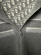 Close-up of hoodie zipper and off-white stripe on gray fabric