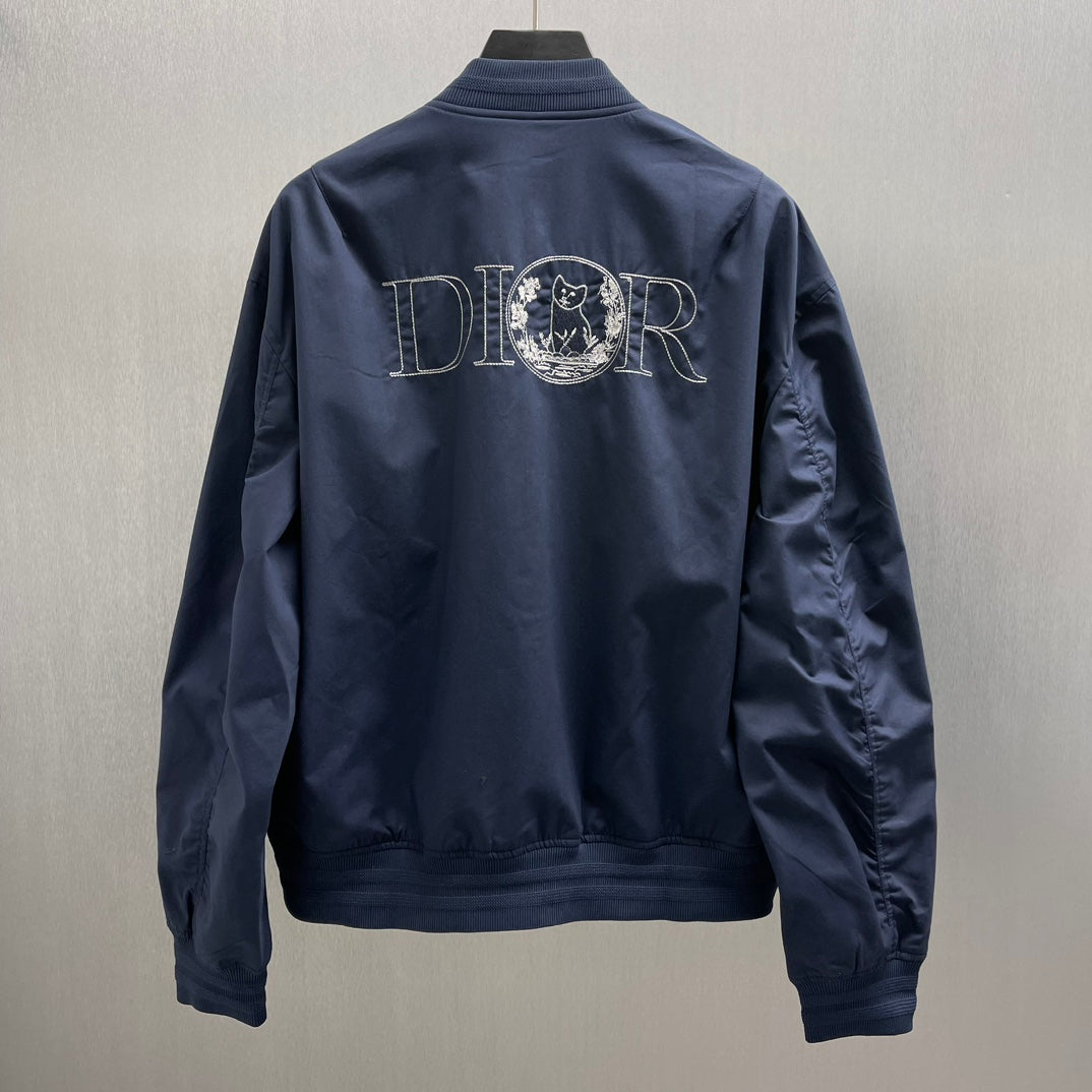 Navy bomber jacket back view with large Dior logo embroidery, ribbed collar and cuffs.