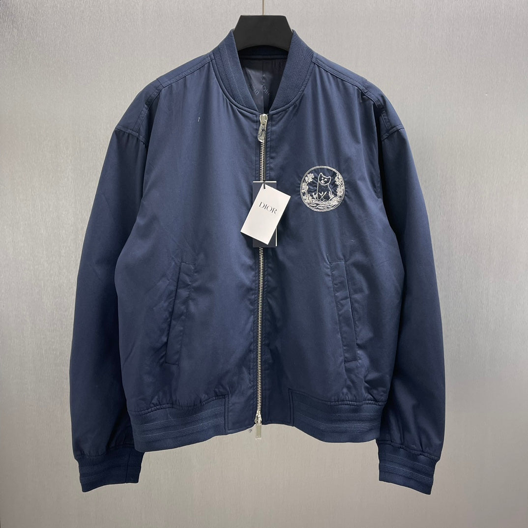 Navy bomber jacket with Dior crest patch, full zip front, ribbed collar and cuffs.