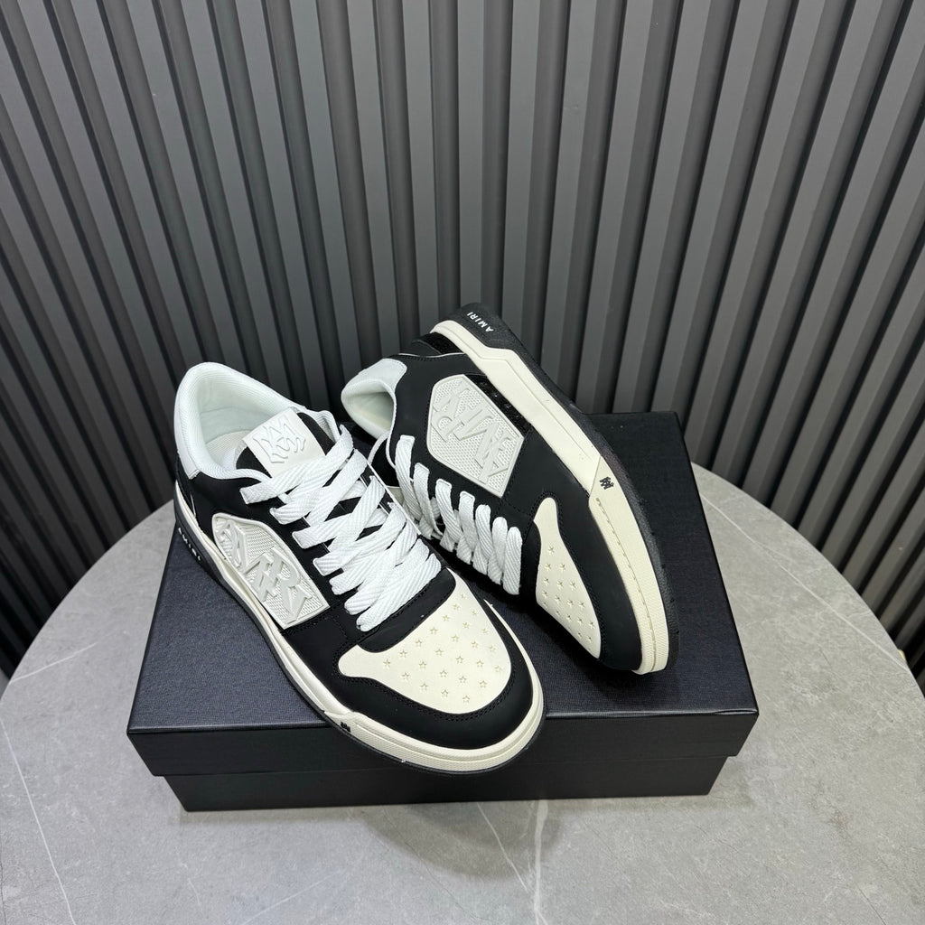 Amiri low-top sneakers, black and white colorblock, white laces, textured sole