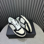 Amiri low-top sneakers, black and white colorblock, white laces, textured sole