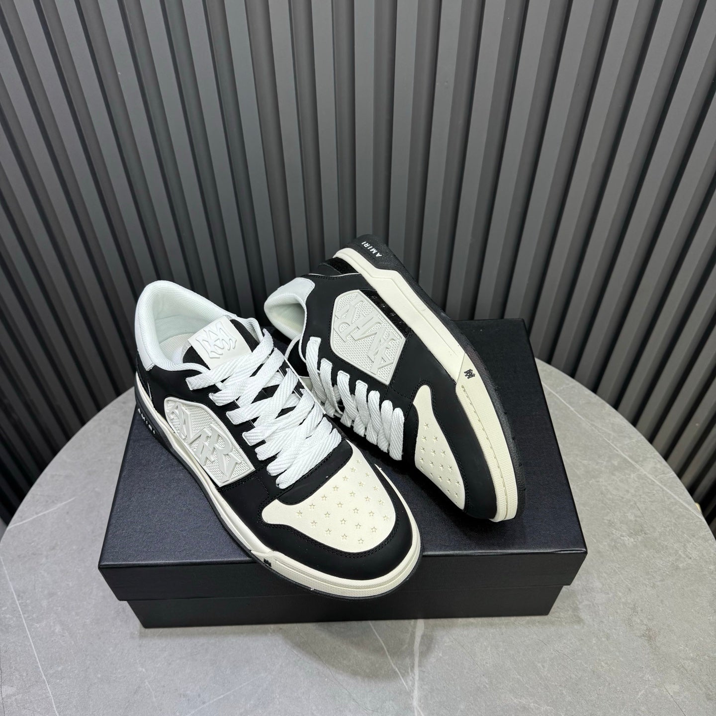 Amiri low-top sneakers, black and white colorblock, white laces, textured sole
