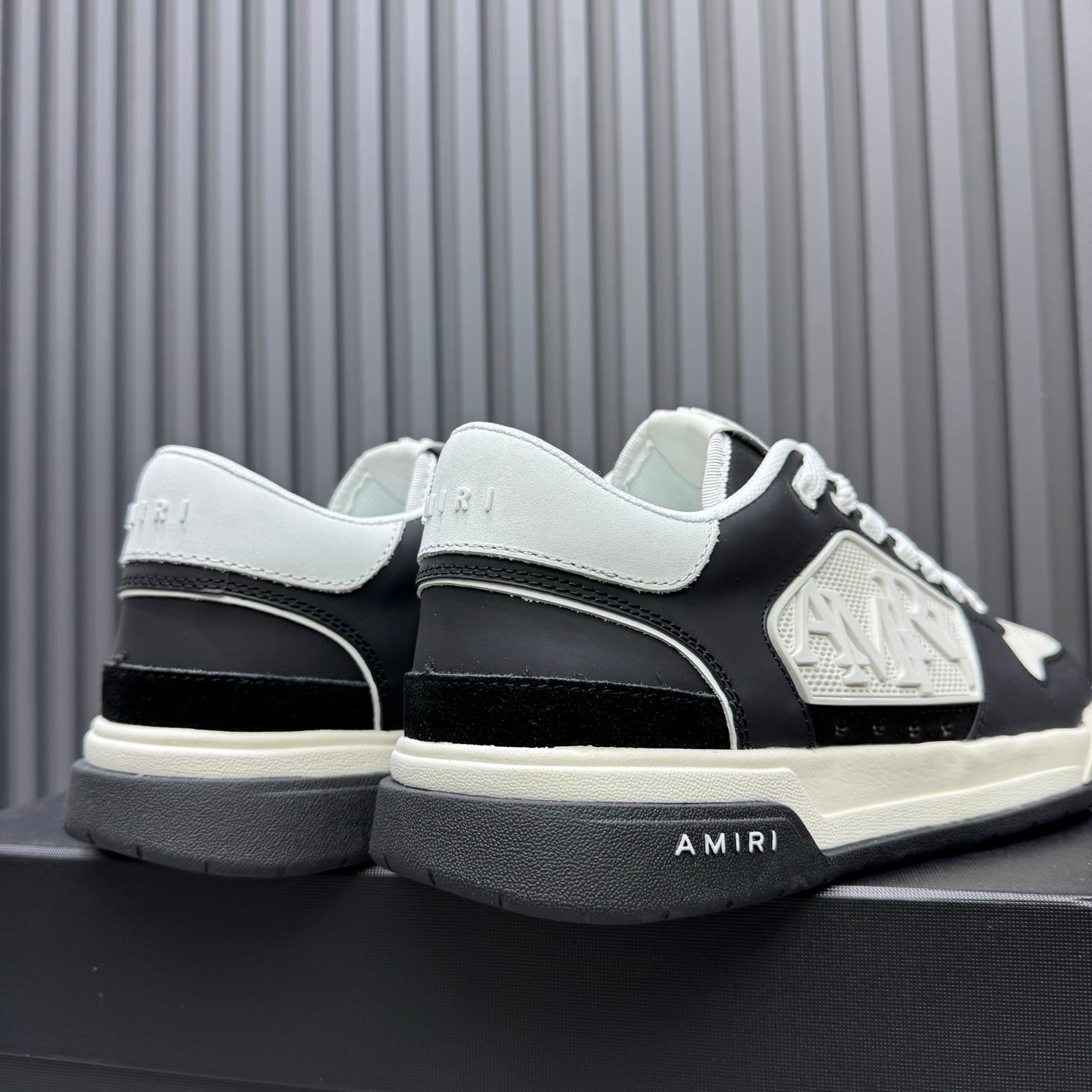 Amiri low-top sneakers, heel and side view in black and white with thick sole
