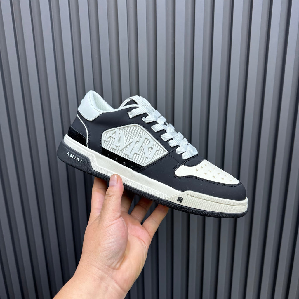 Amiri low-top sneakers, black with white panels and embossed side logo, lace-up