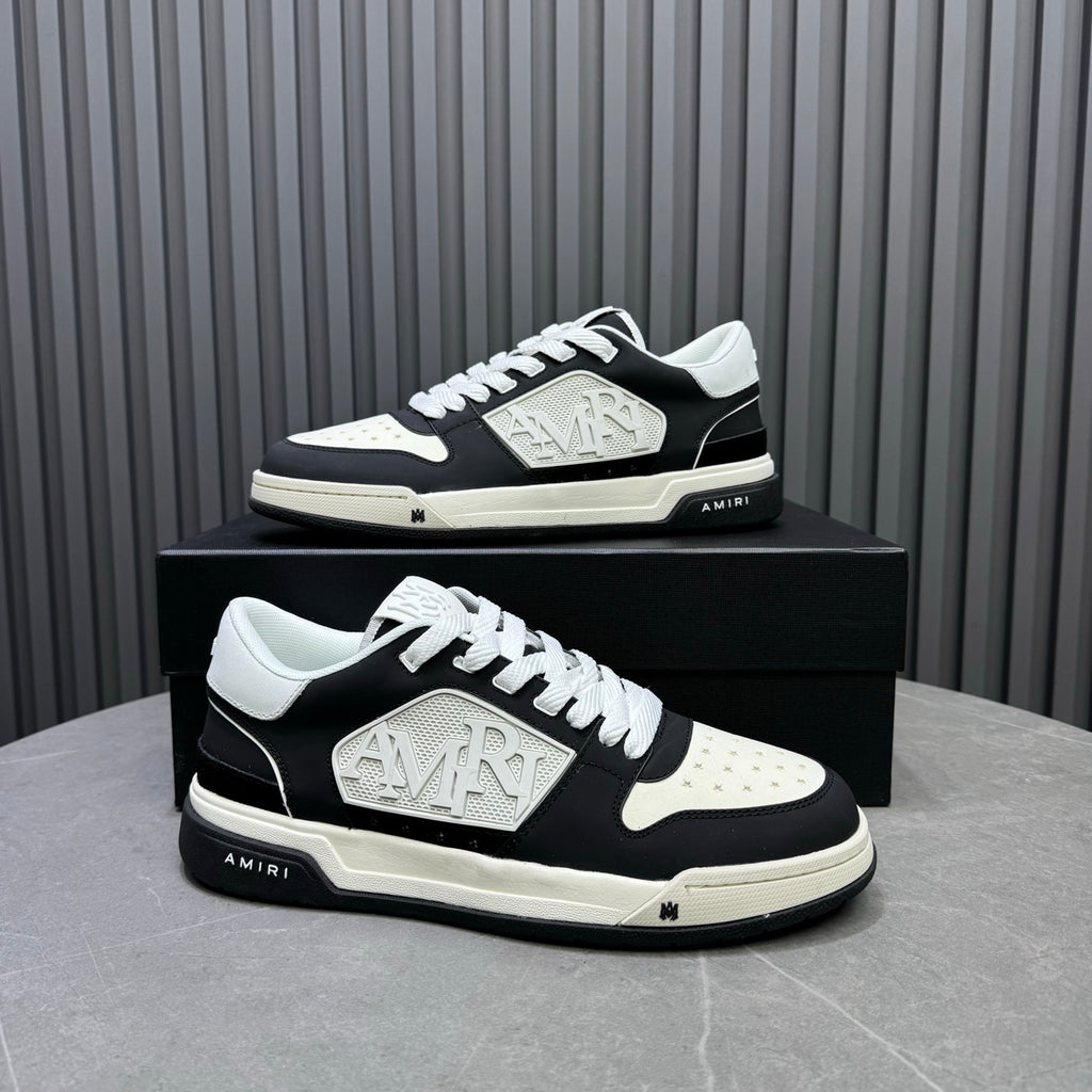 Amiri lace-up sneakers on box, black-and-white side profile with logo plate