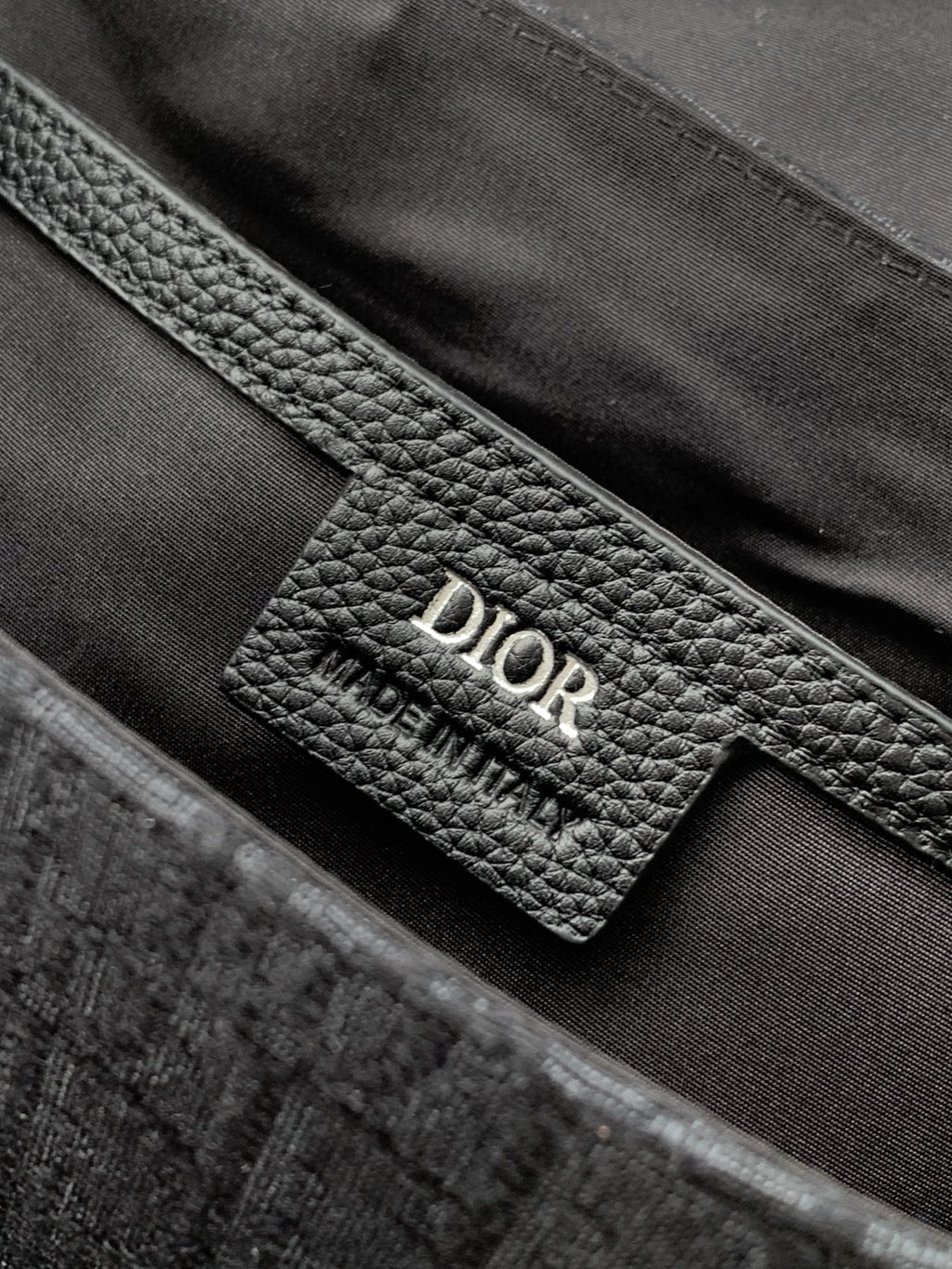 Dior leather interior label on dark gray monogram crossbody bag