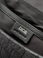 Dior leather interior label on dark gray monogram crossbody bag