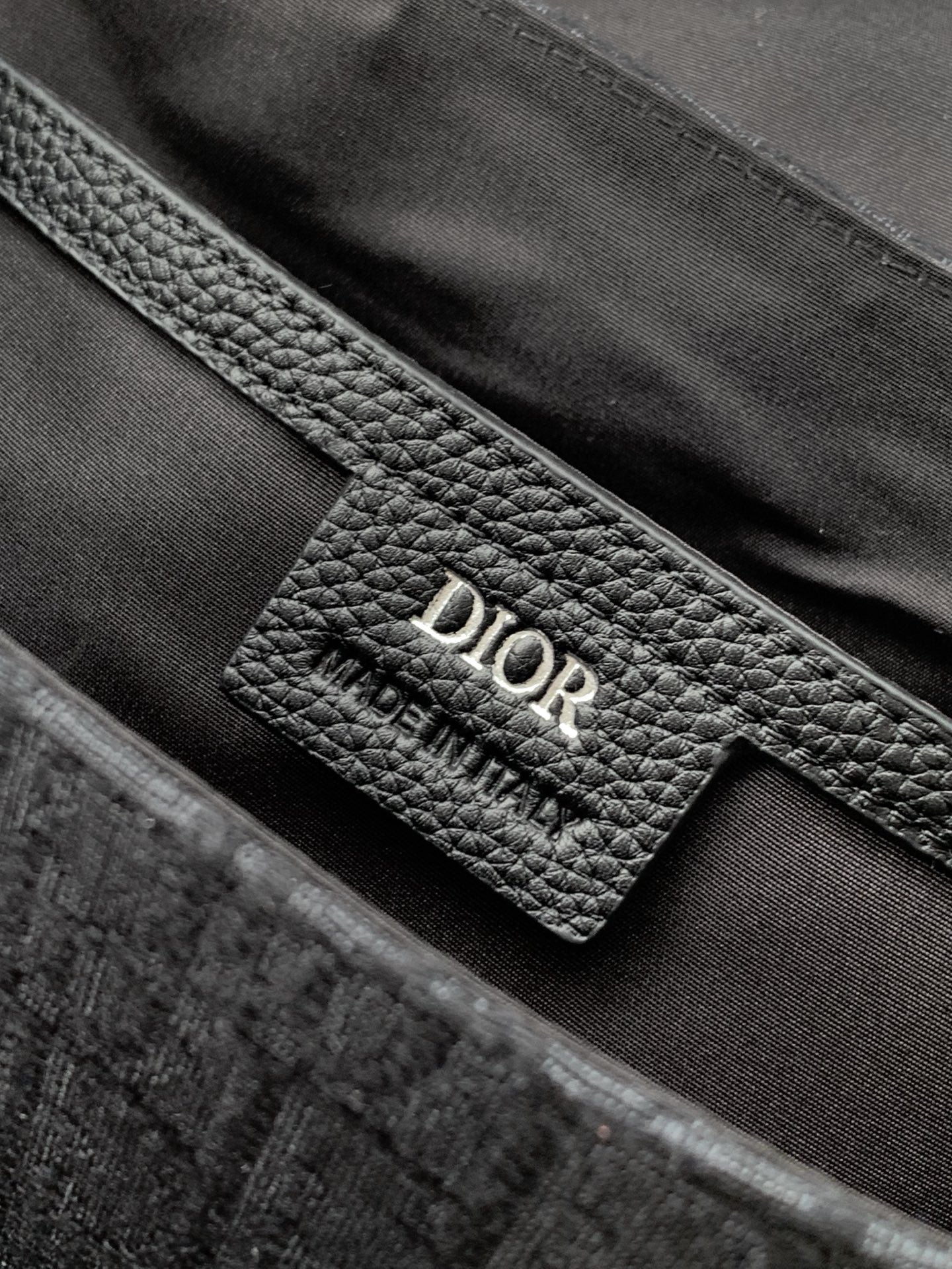 Dior leather interior label on dark gray monogram crossbody bag
