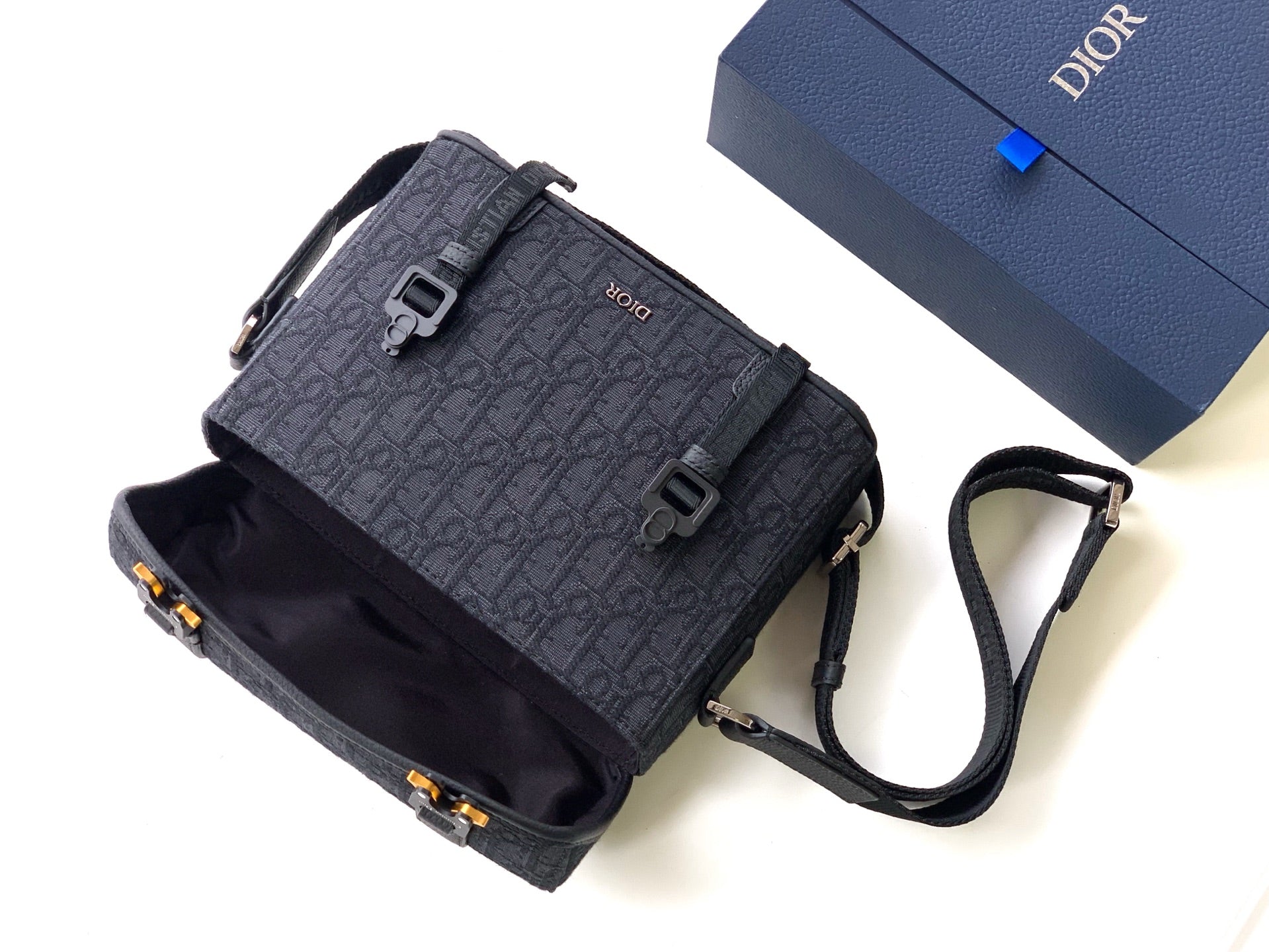 Dior crossbody bag in dark gray monogram canvas with flap, strap, and small front pocket