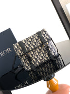 Dior bag with Dior monogram canvas, black leather trim, and top flap closure