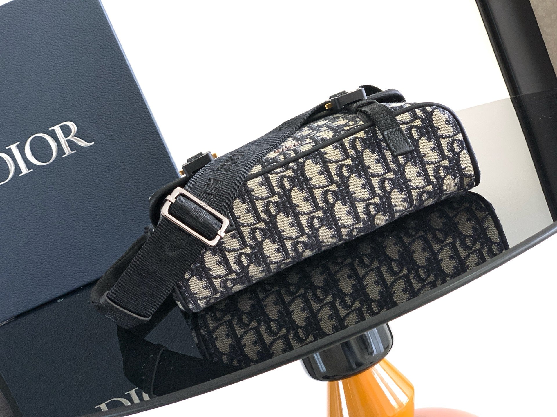 Dior bag with Dior monogram canvas, black front strap and silver-tone buckle